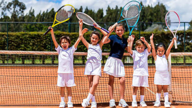 happy group of kids playing tennis
